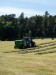 A tractor baling hay