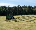 A tractor baling hay
