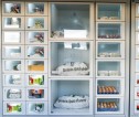 Image of a food larder with various compartments holding local produce including eggs and potatoes
