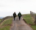 Two people walking a dog