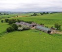 Aerial image of multiple fields and a farm.