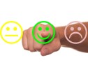 Image of hand selecting smiley face