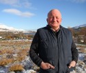 Male farmer with field in background