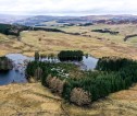 Aerial image of farm (Monzie farm, Pitlochry) with water and trees 