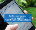 Picture of phone with text detailing Scottish Broadband Voucher Scheme